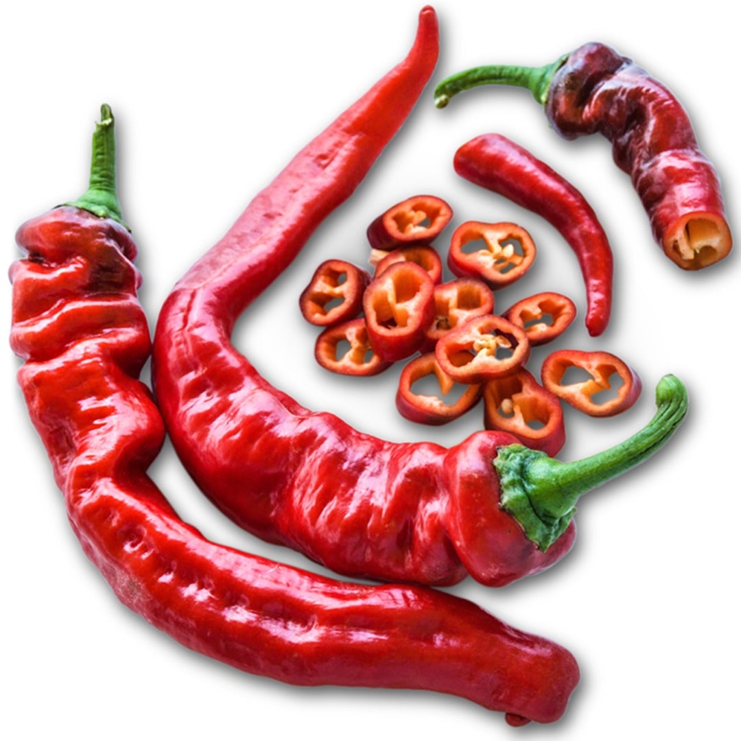 Whole and sliced Jimmy Nardello Italian Sweet Peppers on a white background.