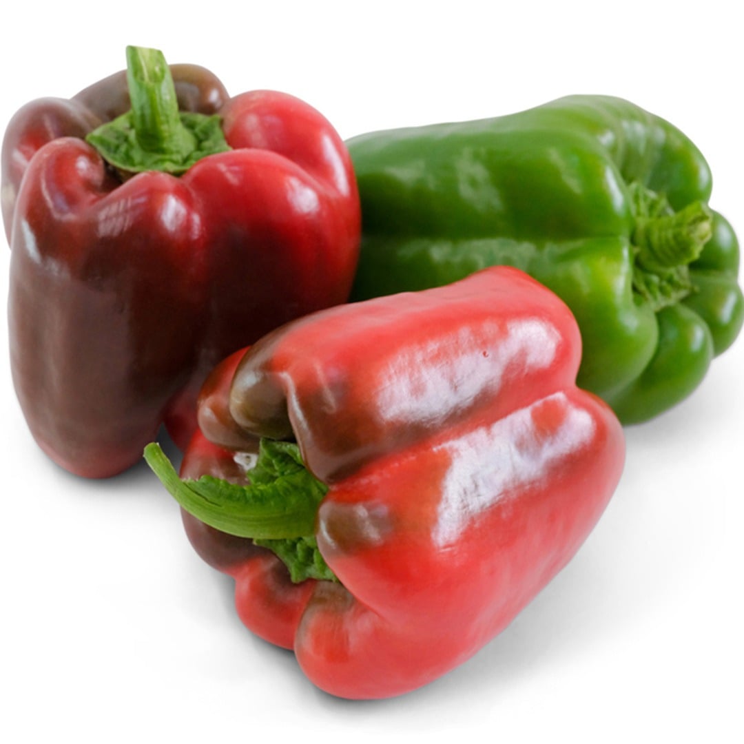 Three King of the North Sweet Peppers, one green and two red on a white background.
