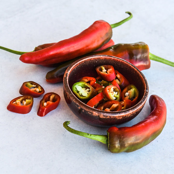 Tunisian Baklouti Pepper slices in a bowl on light background.