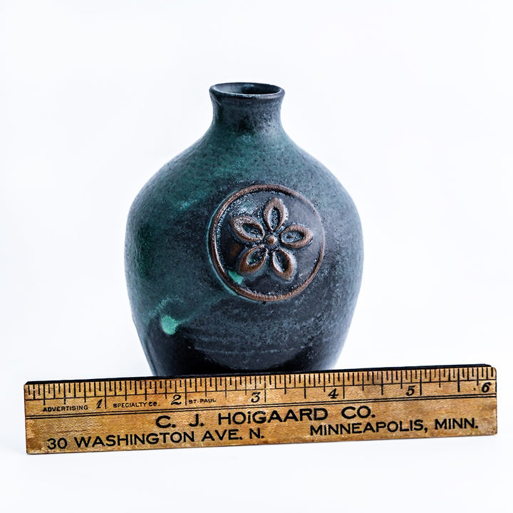 A Handmade Mini Stoneware Bud Vase with a ruler to show the size on a white background.