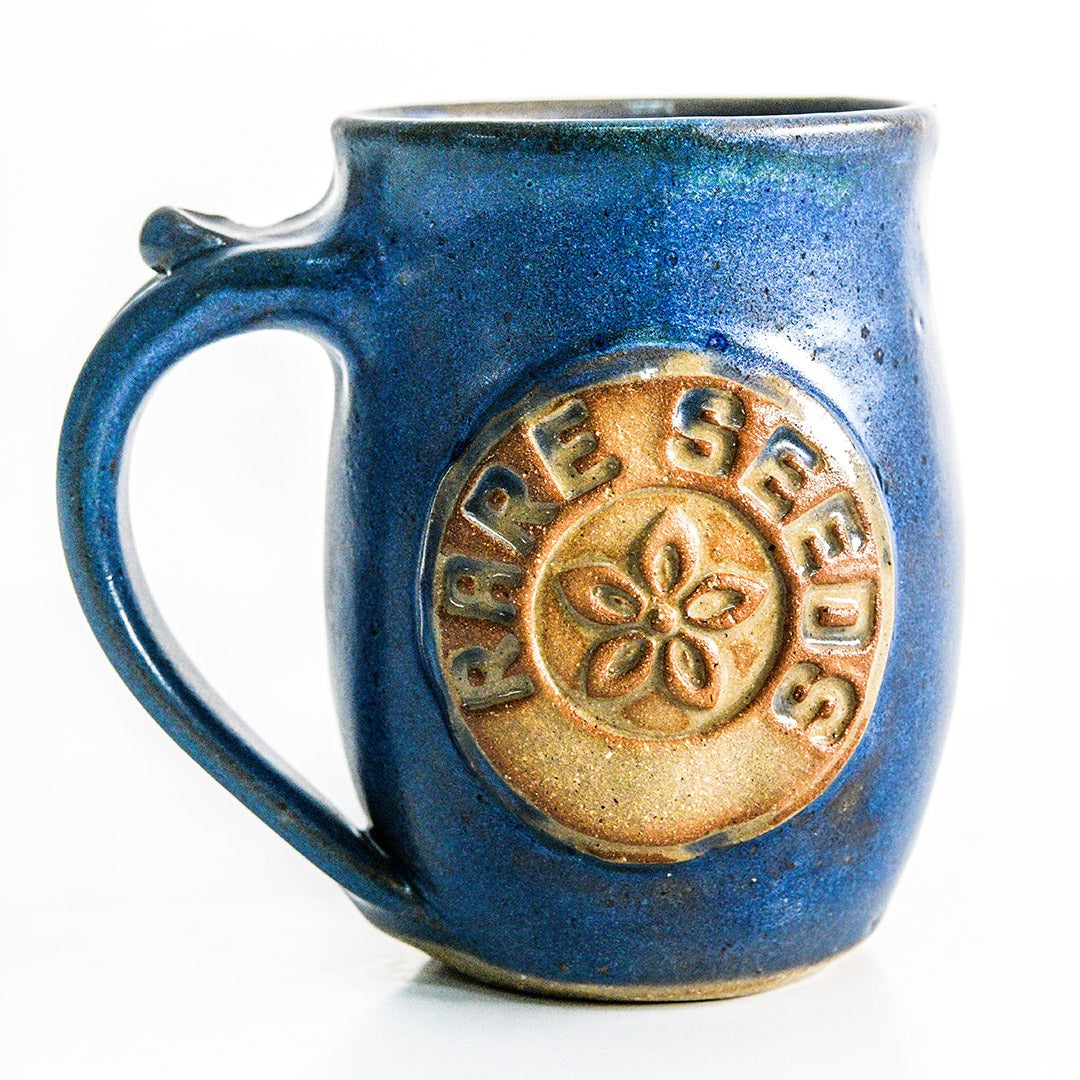 Handmade Local Mug Blue/Grey Pottery with a rareseeds logo on white.