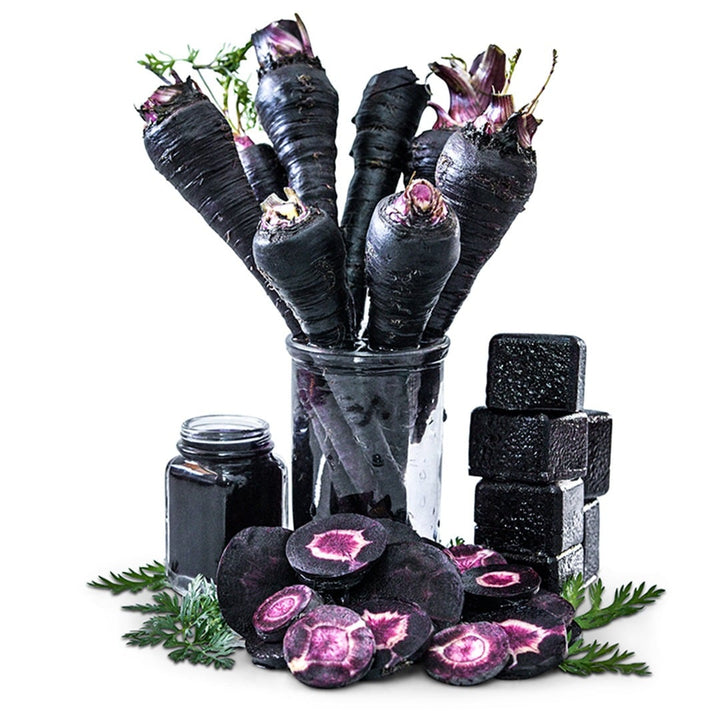 Whole carrots in a glass jar with sliced carrots and greenery surround