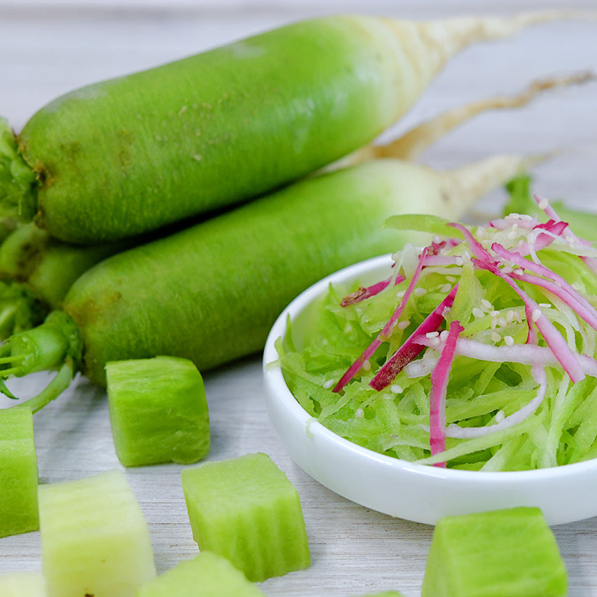 Chinese Shawo Fruit Radish salad with whole and cut radishes on a light background.
