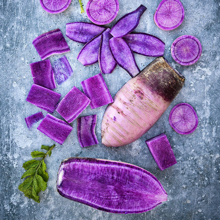 Cut Pusa Jamuni Radishes arranged on grey background.