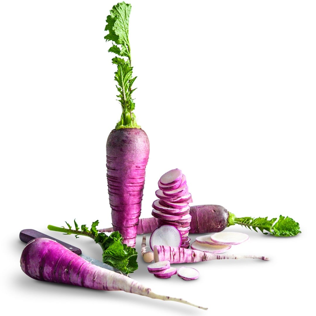 Whole and sliced Blue Autumn Radishes on a white background.