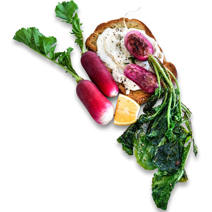 French Breakfast Radishes on a slice of toast with egg on a white background.