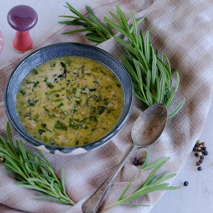 Rosemary soup on light tan, checkered table cloth.