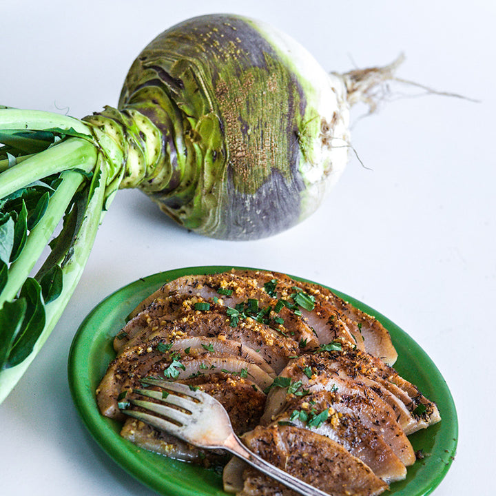 A Macomber Turnip Rutabaga with roasted and seasoned rutabaga on a white background.