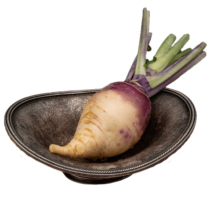 Marian Rutabaga in a metal dish on a white background.