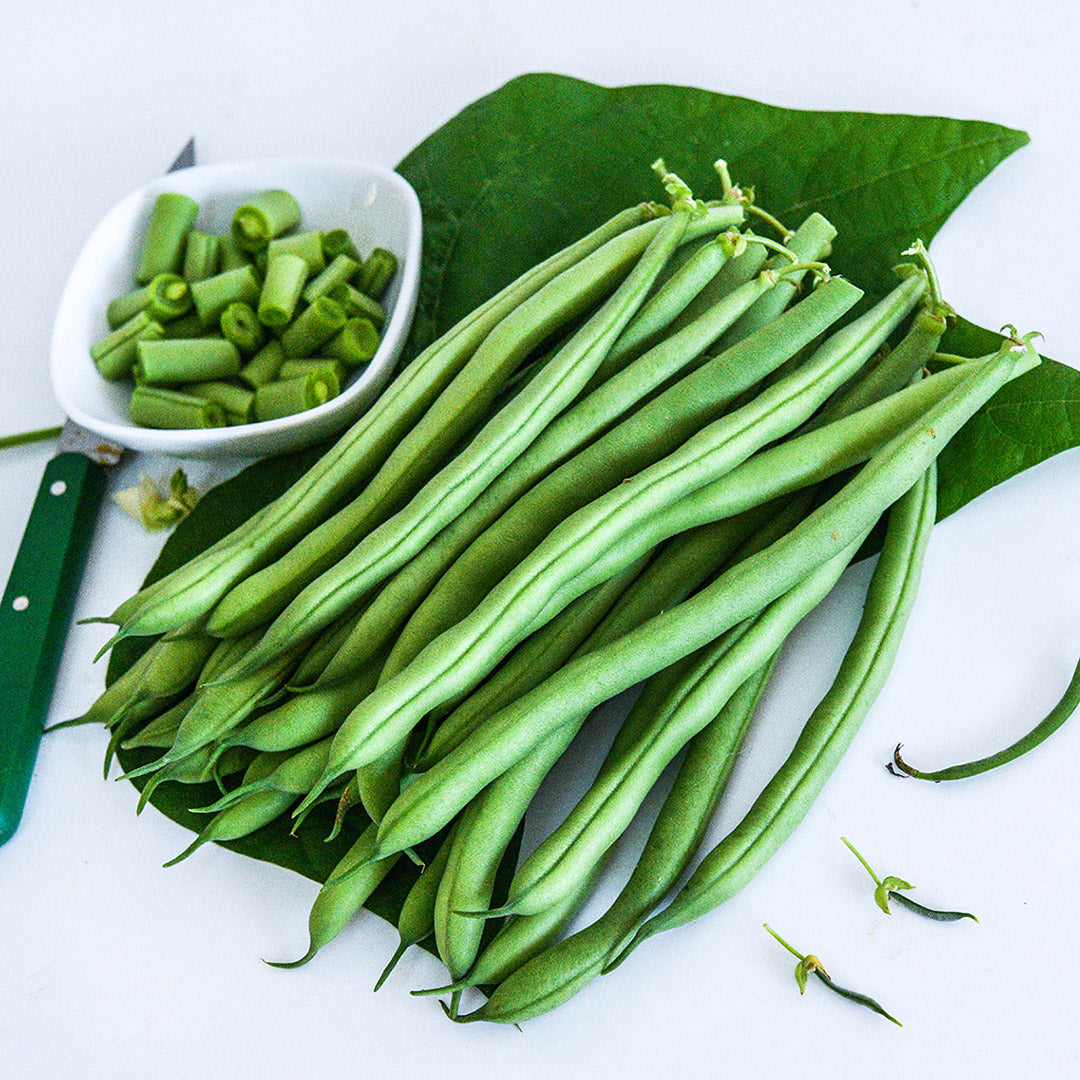 Whole and cut Derby Beans arranged on a light background.