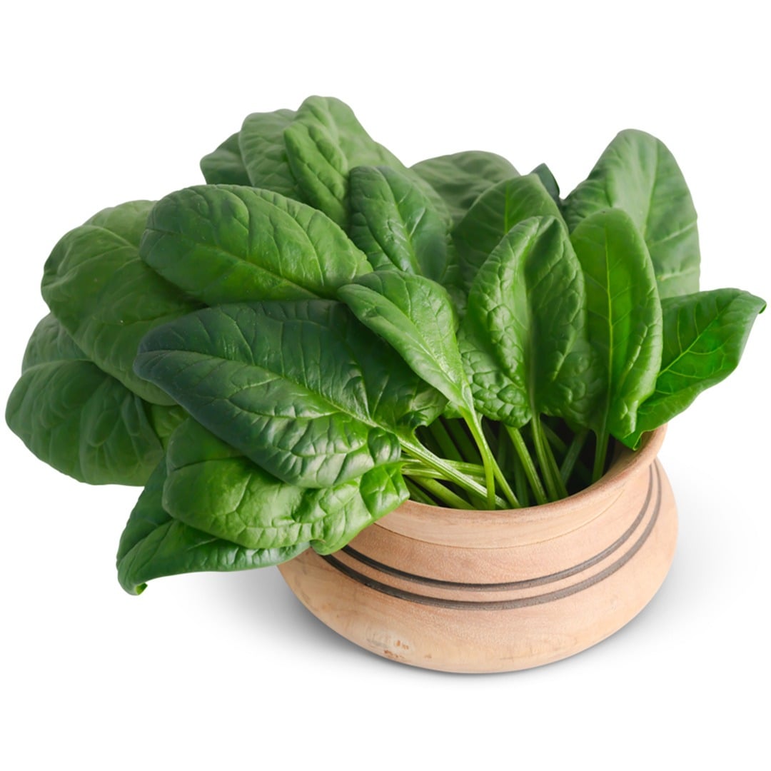 Merlo Nero Spinach leaves in a wooden bowl on a white background.