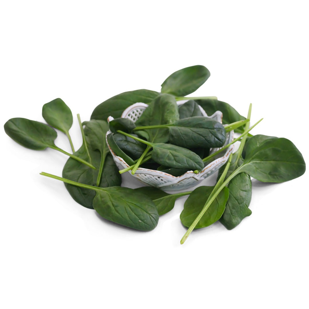 Monnopa Spinach leaves in a white dish on a white background.