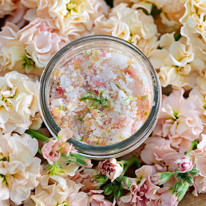 A close-up of Chanter Cedo Apricot Stock sugar in a jar on bed of stock flowers.