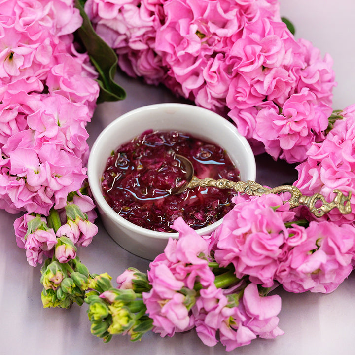 Venus Pink Stock with cherry jam made with the stock flowers in dish with a fancy spoon.
