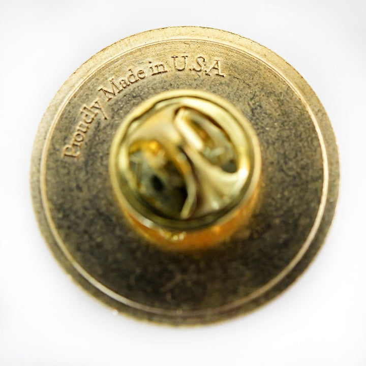 A macro close-up view of the back of a single Black Forest Ruby Dahlia Limited Edition Pin on a white background.