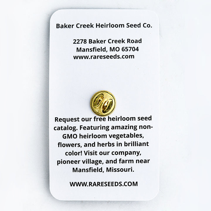 The backside of the Orange Hat Tomato Limited Edition Pin packaging on a white background.