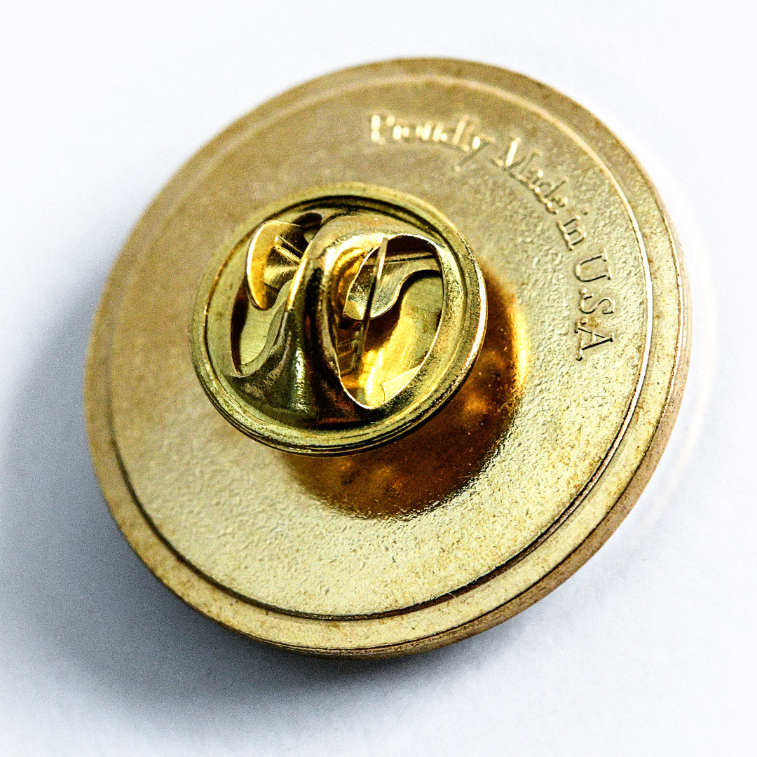 The back side of the Orange Hat Tomato Limited Edition Pin showing "Proudly Made in U.S.A."