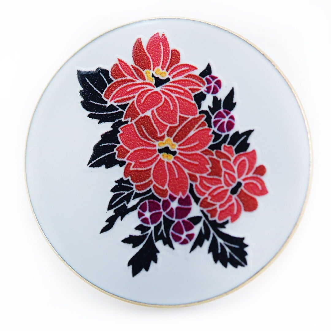 A macro close-up view of a single Black Forest Ruby Dahlia Limited Edition Pin on a white background.