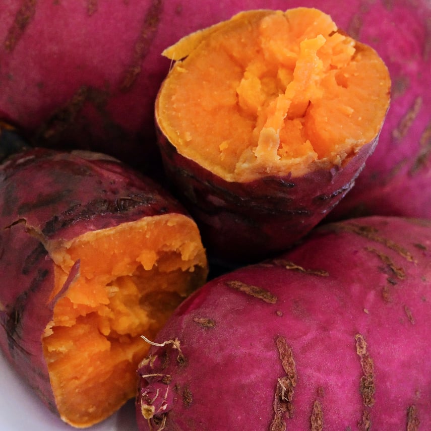 A close-up view of raw and cooked Carogold Sweet Potatoes.