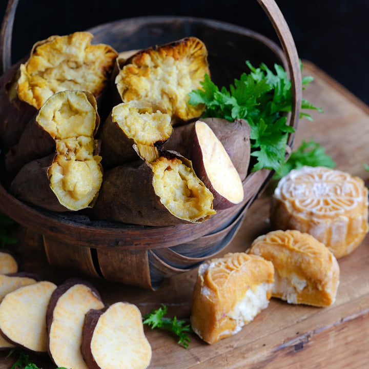 Sliced and cooked Korean Gold Sweet Potato in a small basket on a wood cutting board.