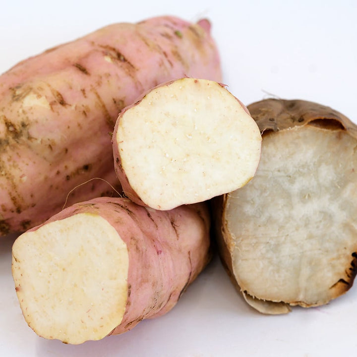 Cooked and raw Seon Mi Sweet Potato Plants on a white background.