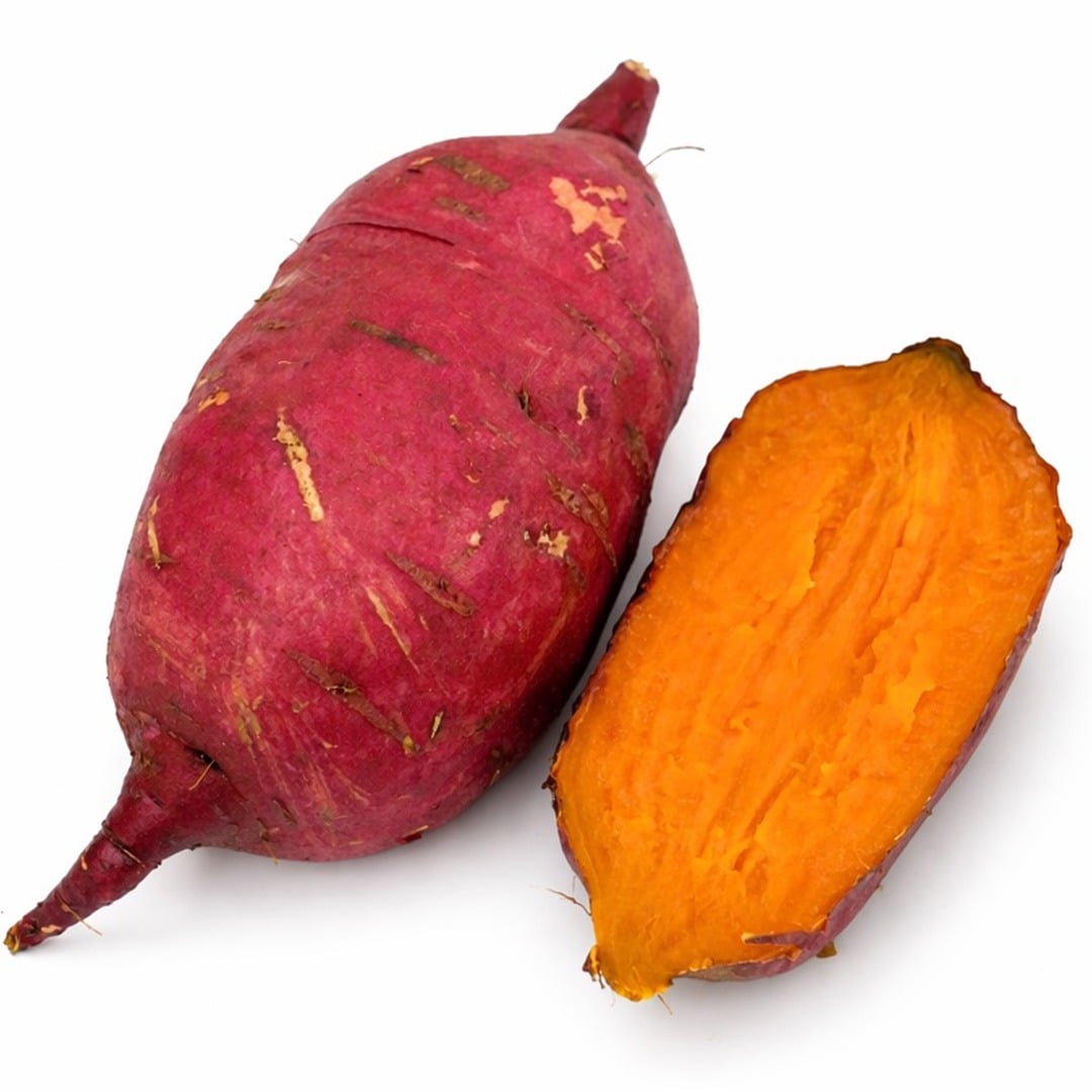 A couple of raw and cooked Carogold Sweet Potatoes on a white background.