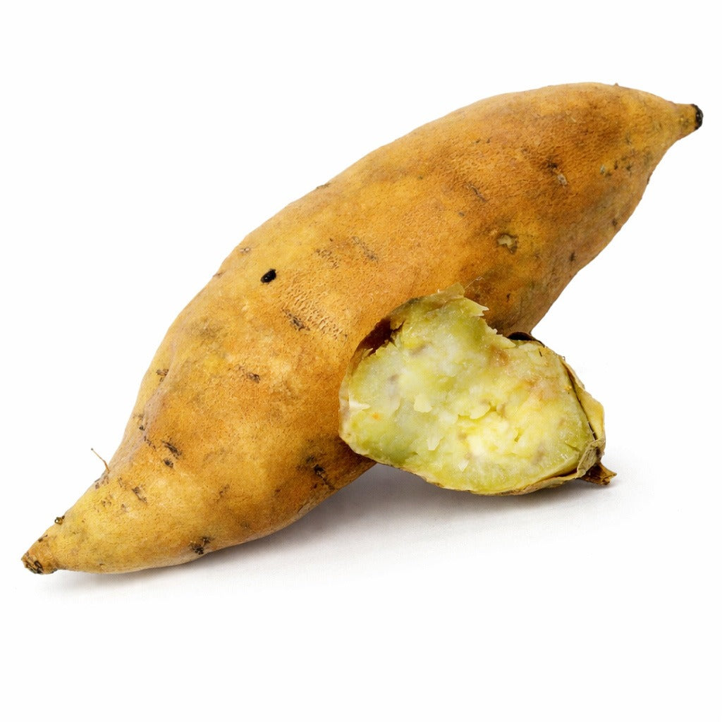 Cooked and whole raw Korean Gold Sweet Potatoes on white.