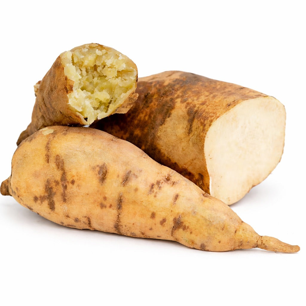 Raw and cooked Nancy Hall Sweet Potatoes arranged on white background.