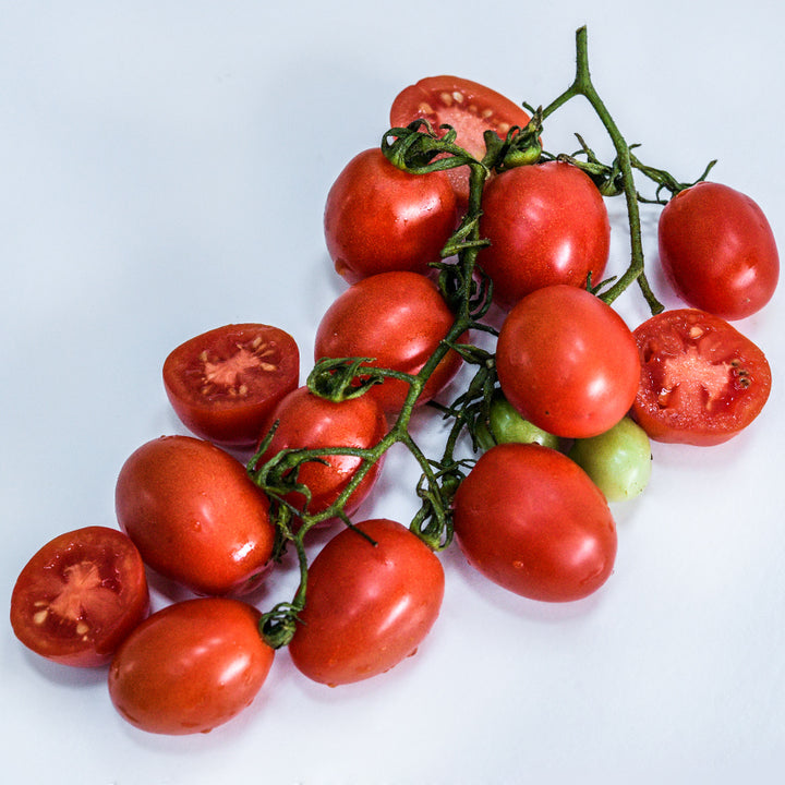 A cluster of A Grappoli D'Inverno Tomatoes on white background.