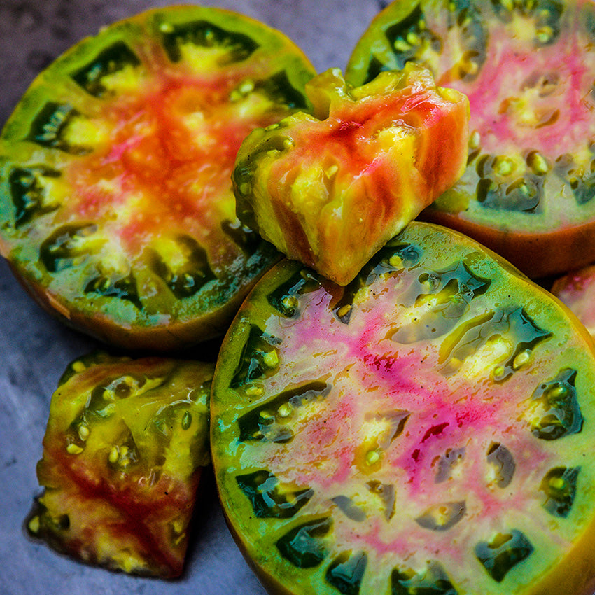 Ananas Noire or Black Pineapple Tomatoes slice showing the brightly multi-colored flesh inside.