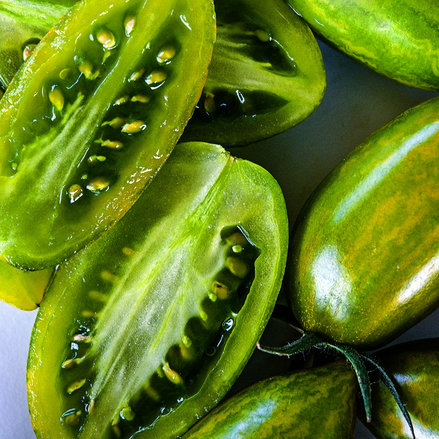 Macro close-up detailed view of Green Tiger Tomato slices.