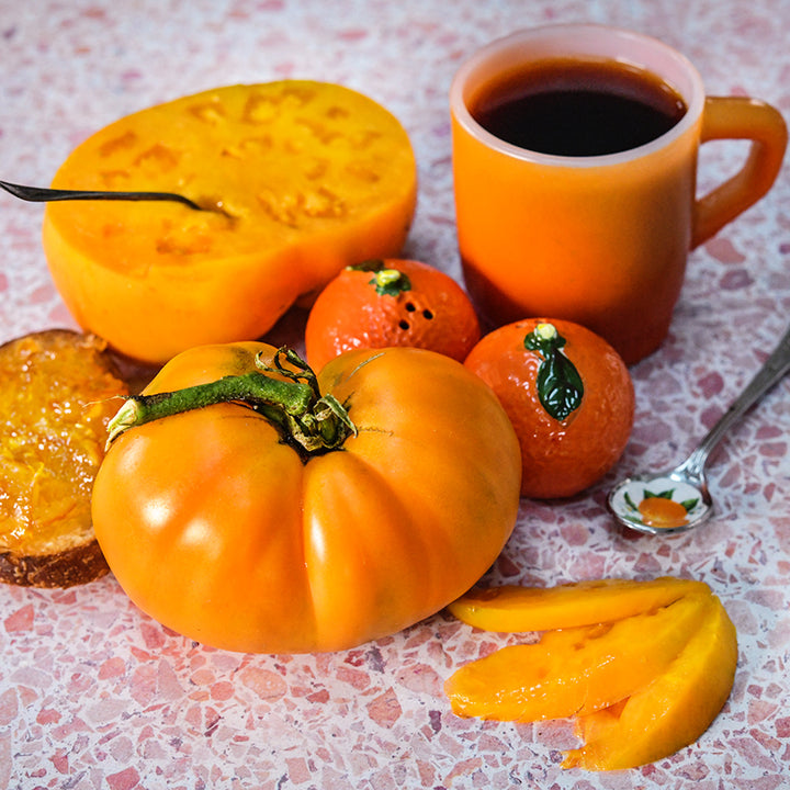 Kellogg's Breakfast Tomatoes with coffee and toast with orange jam on a speckled linoleum countertop.