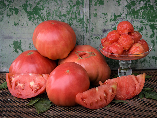 Large stacked Watermelon Beefsteak Tomatoes with scooped tomato "balls" made to look like melon balls.