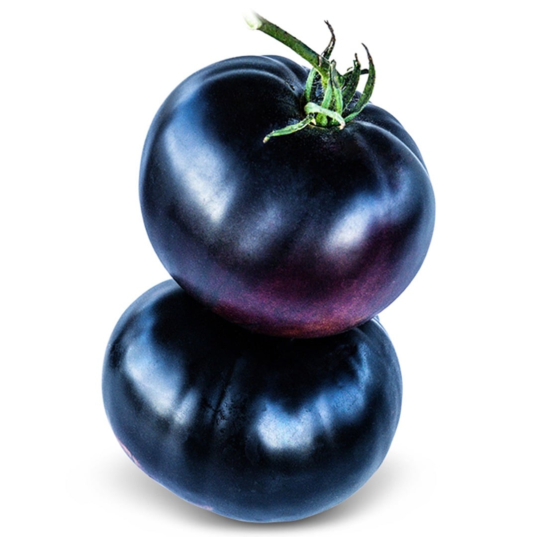 Pair of Black Beauty Tomatoes stacked on a white background.