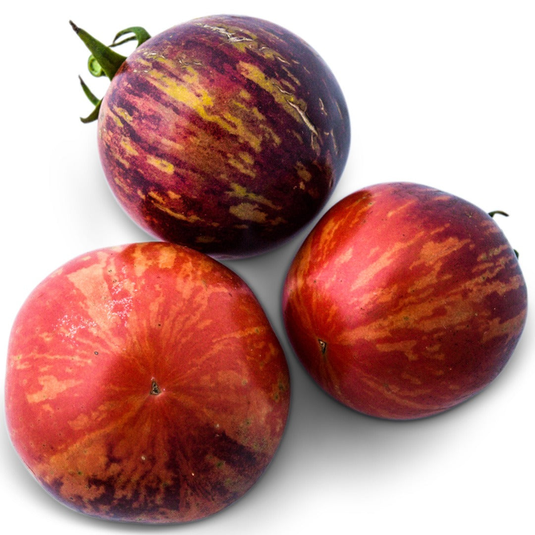 A trio of Black Strawberry Tomatoes on a white background.