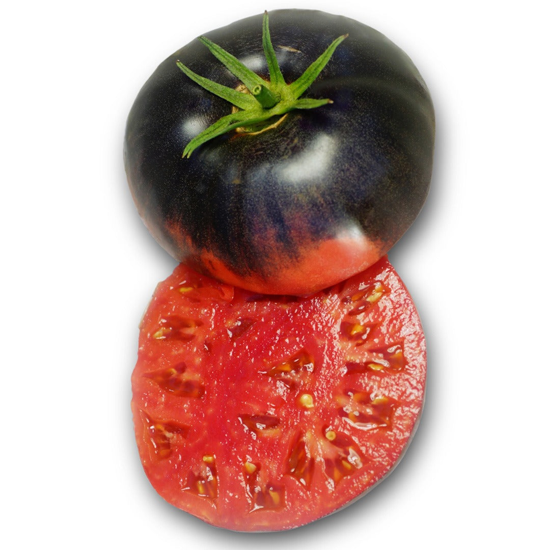 A single Blue Beauty Tomato sliced in half on a white background.