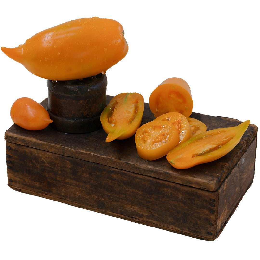 Buratino or Pinocchio Tomatoes arranged creatively on a wooden block against a white background.