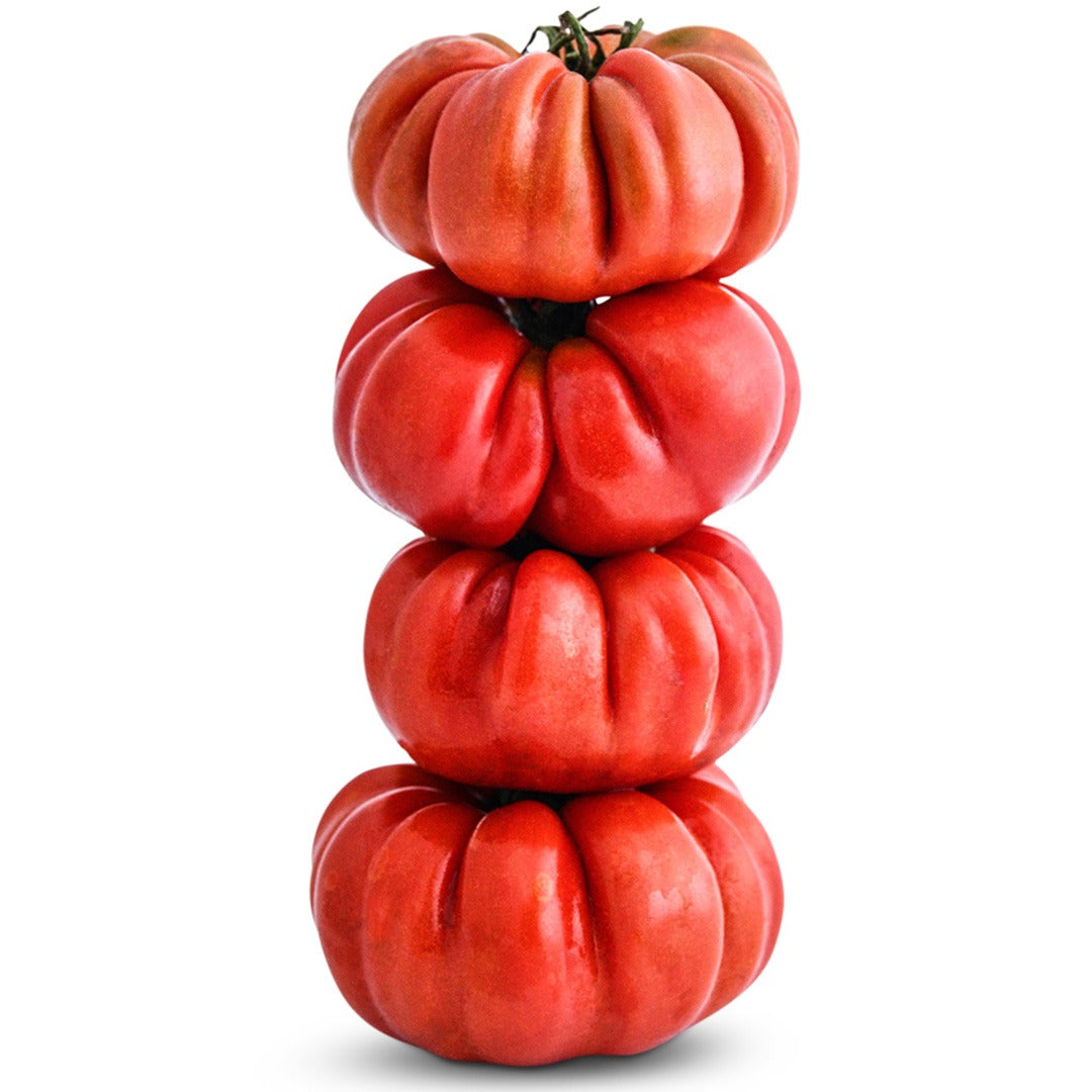 Four Burmese Sour Tomatoes stacked on a white background.