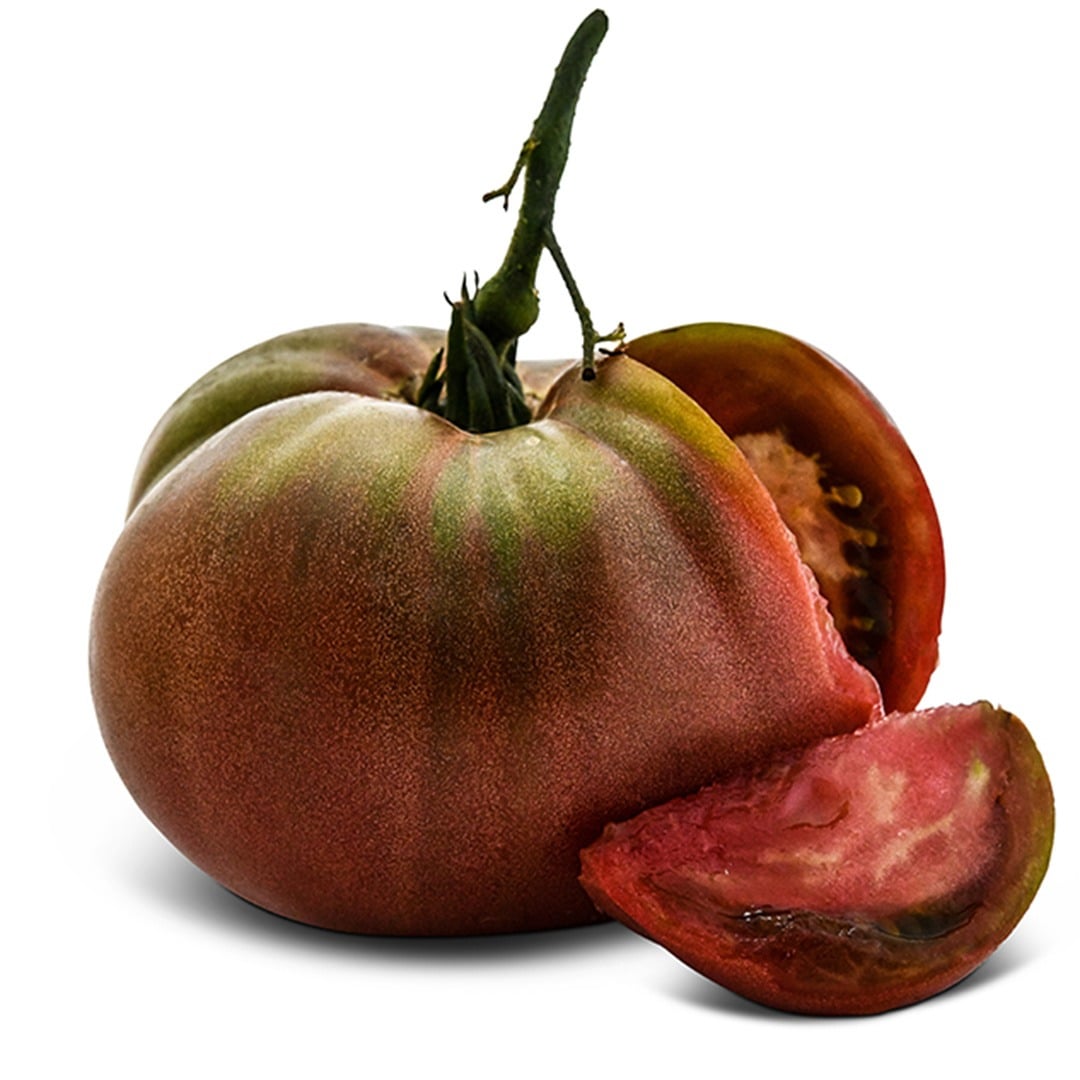 Single Carbon tomato with a slice removed on a white background.