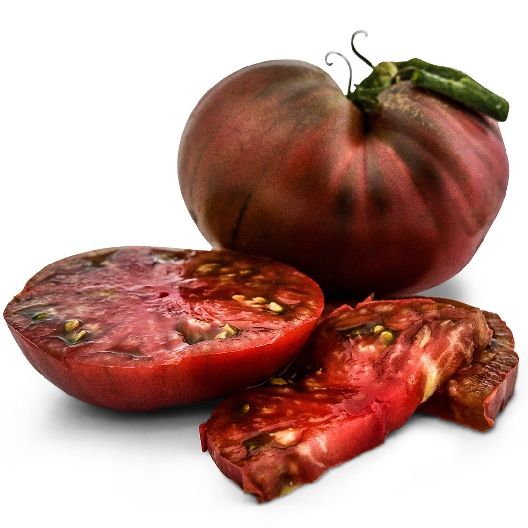 Cherokee Purple Tomatoes with slices on a white background.