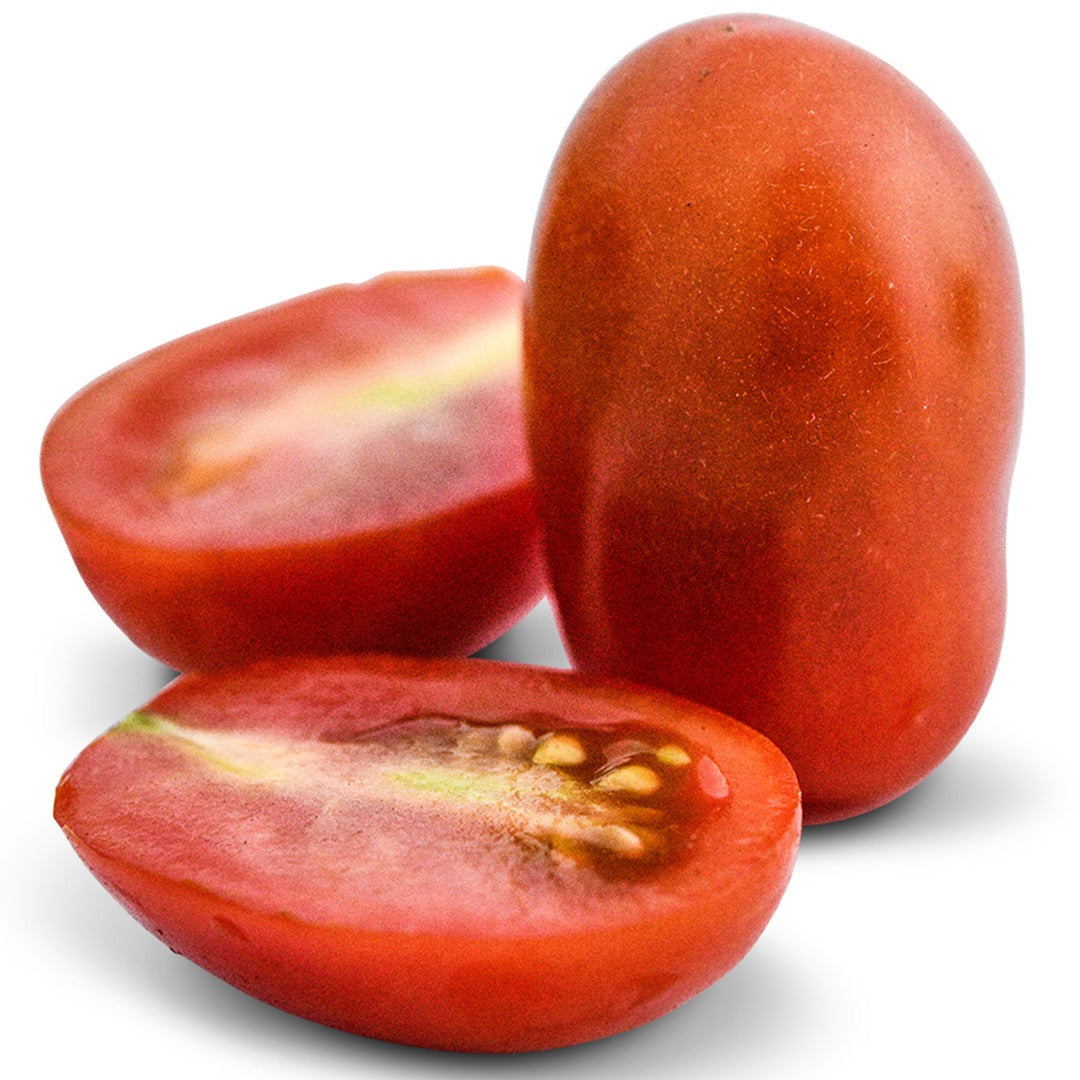 One whole and one cut Cherry Flaviola Tomatoes on a white background.