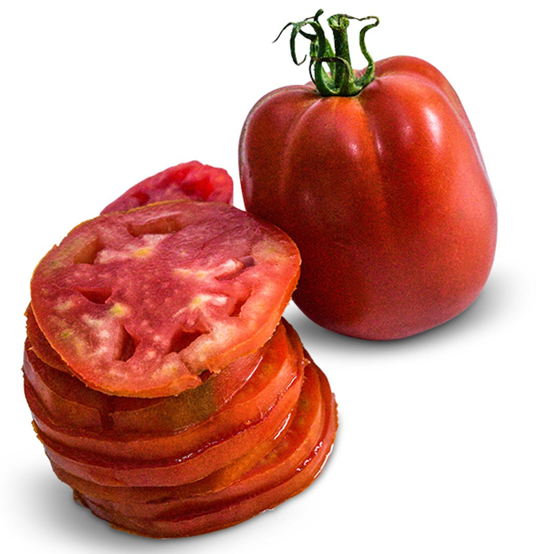 One whole and one sliced Comstock Sauce and Slice Tomatoes on a white background.