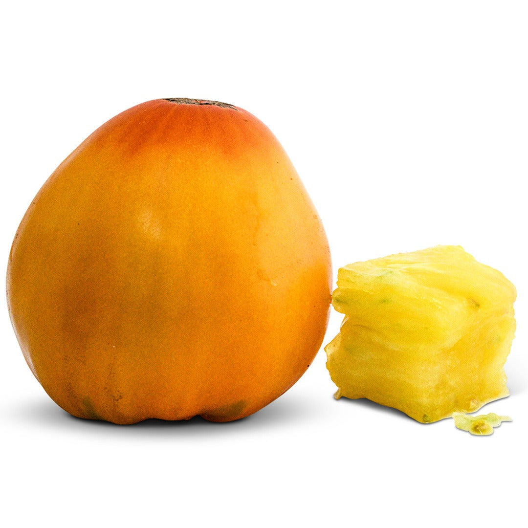 Whole and cut Golden King of Siberia Tomatoes on a white background.