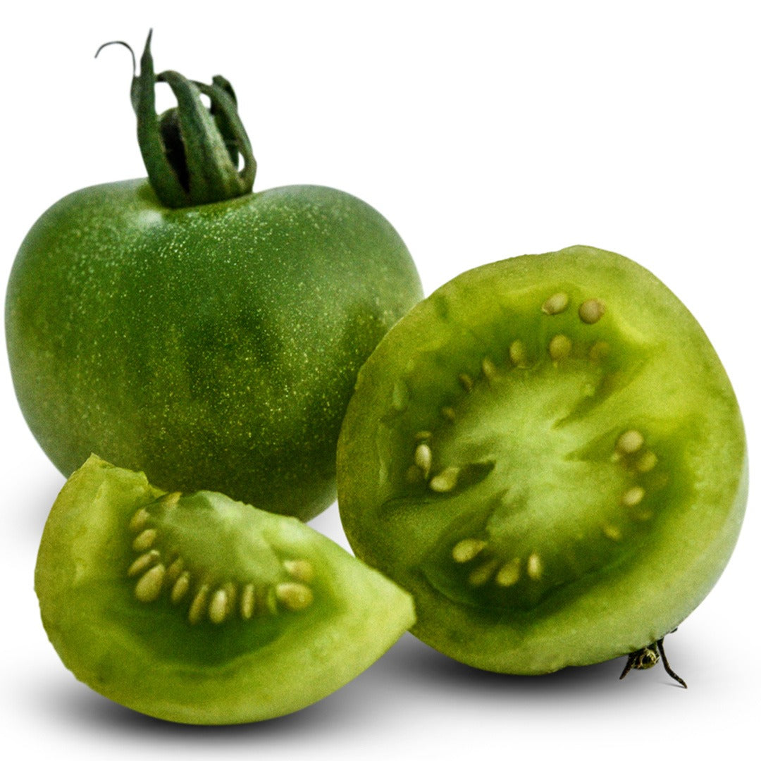 Whole and sliced Green Doctors Tomatoes on a white background.