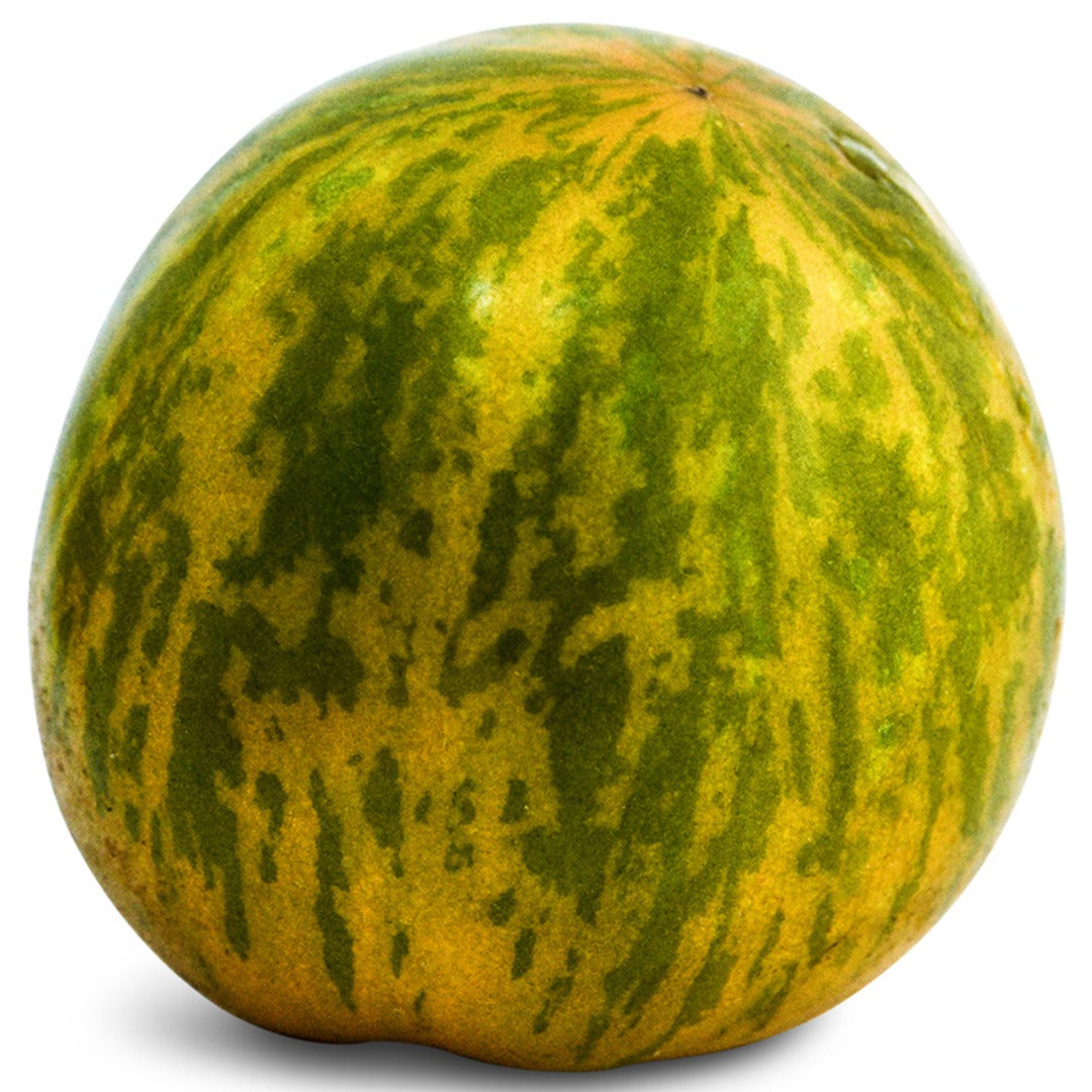 A close up of a Green Zebra Tomato on a white background.