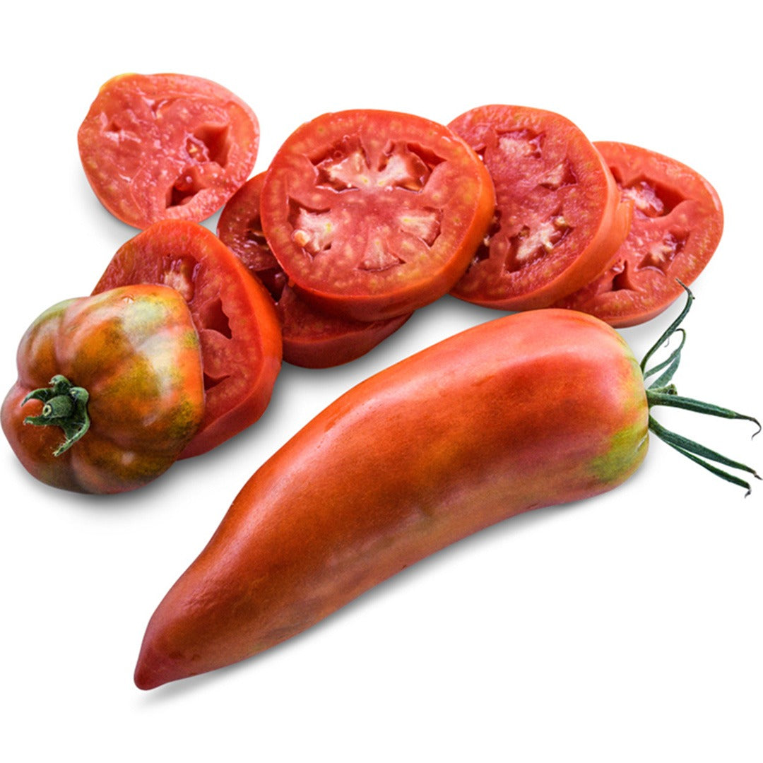 One whole and one sliced Jersey Devil tomato on a white background.