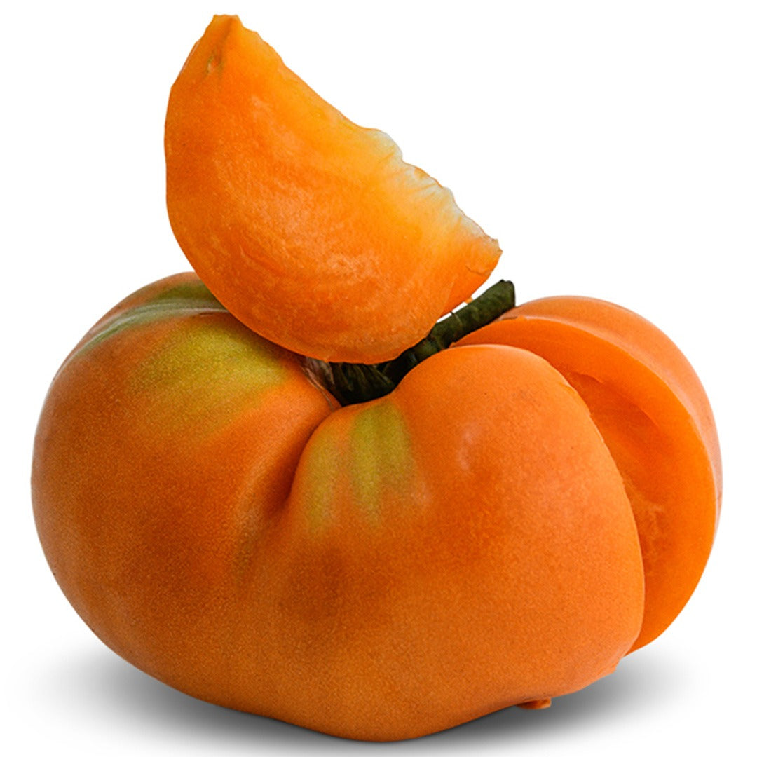 Kentucky Beefsteak Tomato with slice taken out on a white background.