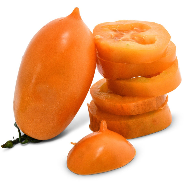 Whole Orange Icicle Tomato next to a sliced tomato on a white background.
