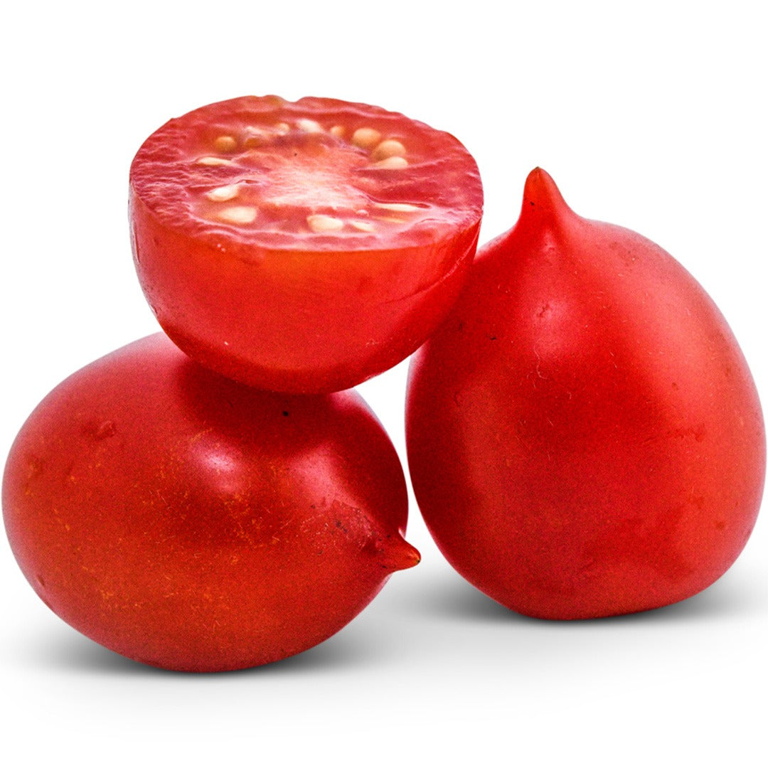 Whole and sliced Principe Borghese Tomatoes on a white background.