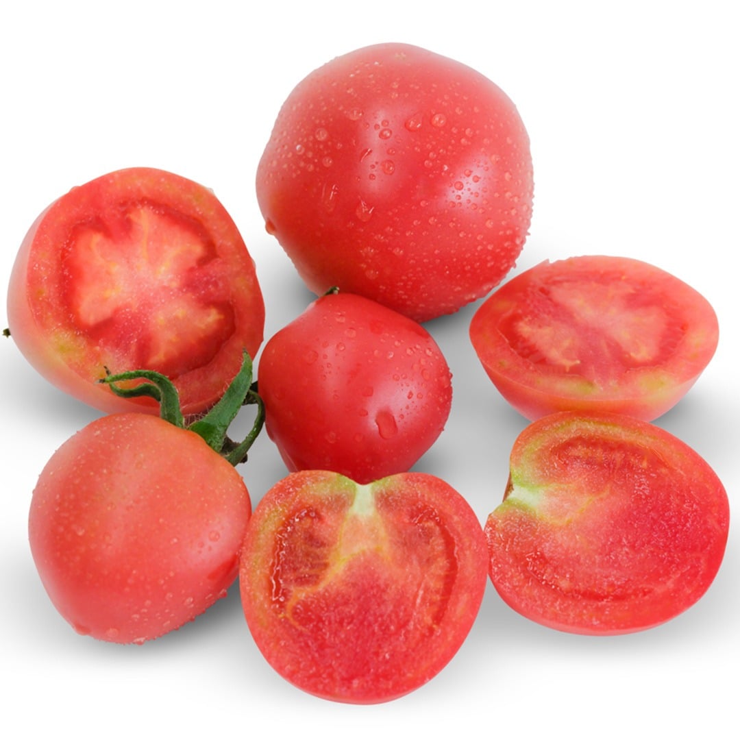 Whole and sliced Raspberry Lyanna Tomatoes on a white background.